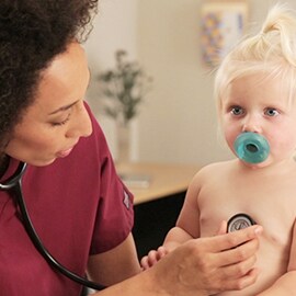 Paediatric nurse listening to the chest of a toddler with a 3M Littmann Classic III Stethoscope. 